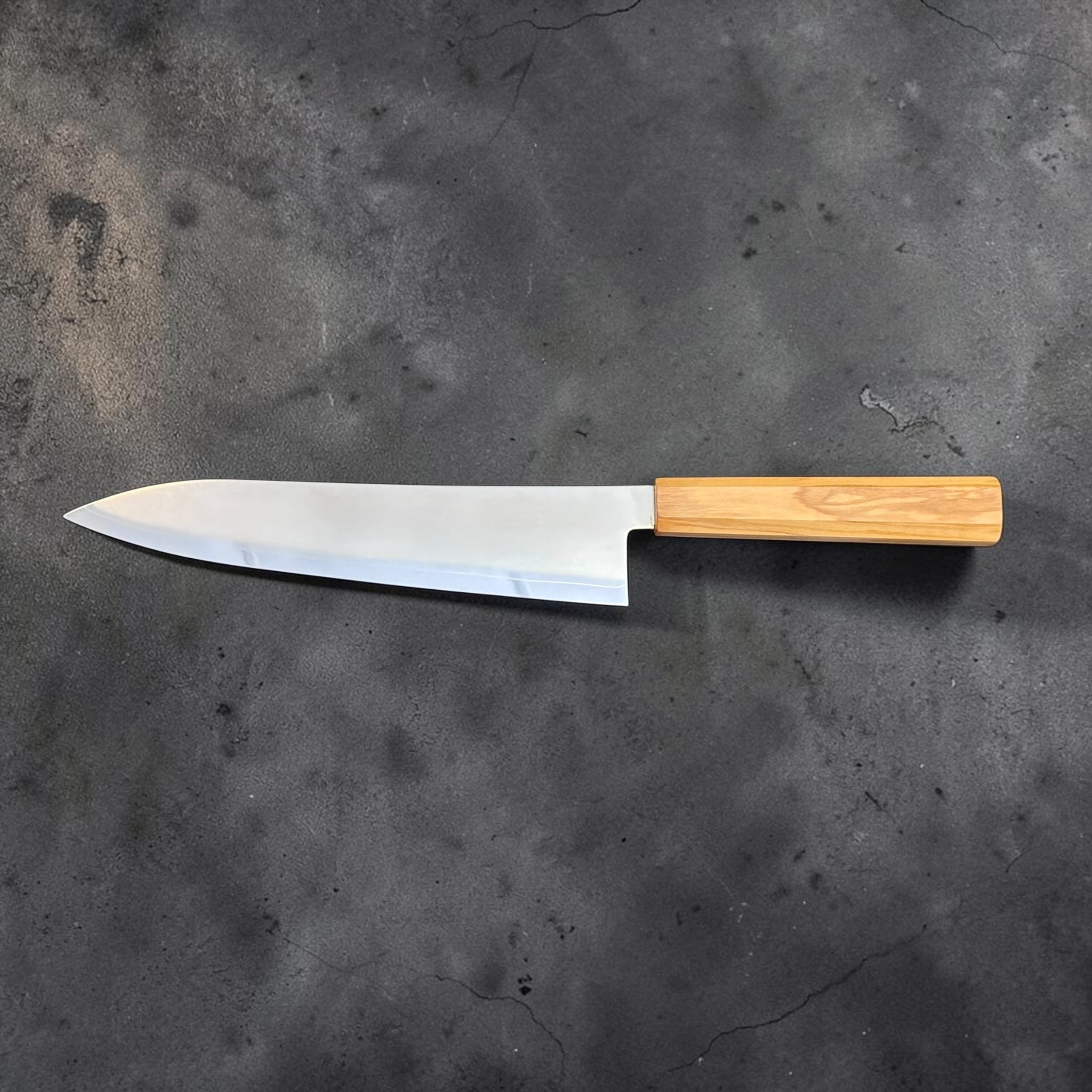 Hatsukokoro Kaijin Blue #2 Gyuto 210 mm with mono olive wood handle, left-facing profile view.