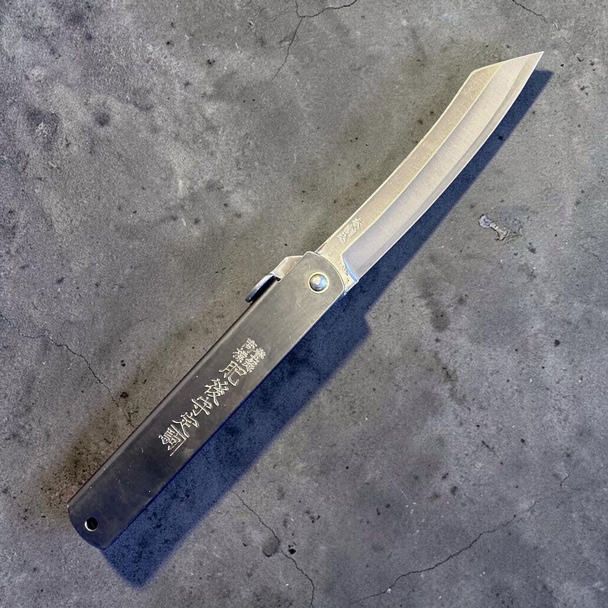 Higonokami Carbon Steel Japanese Friction Folder, three-quarter product view with blade open. #size_large - black