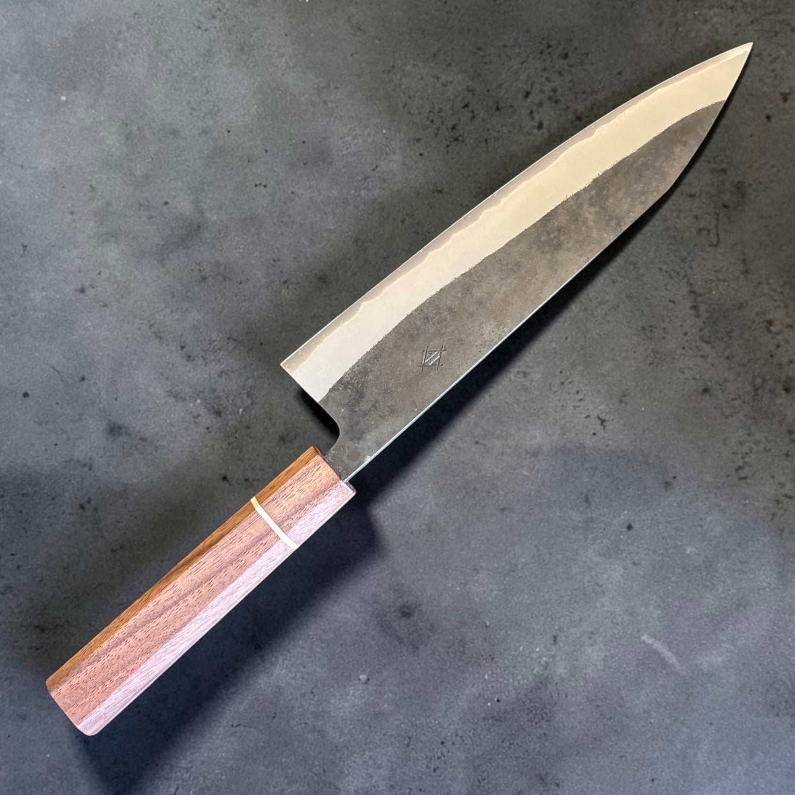 Angled view of the Imai Aogami Super Kurouchi Gyuto 210mm with Sanjo walnut handle