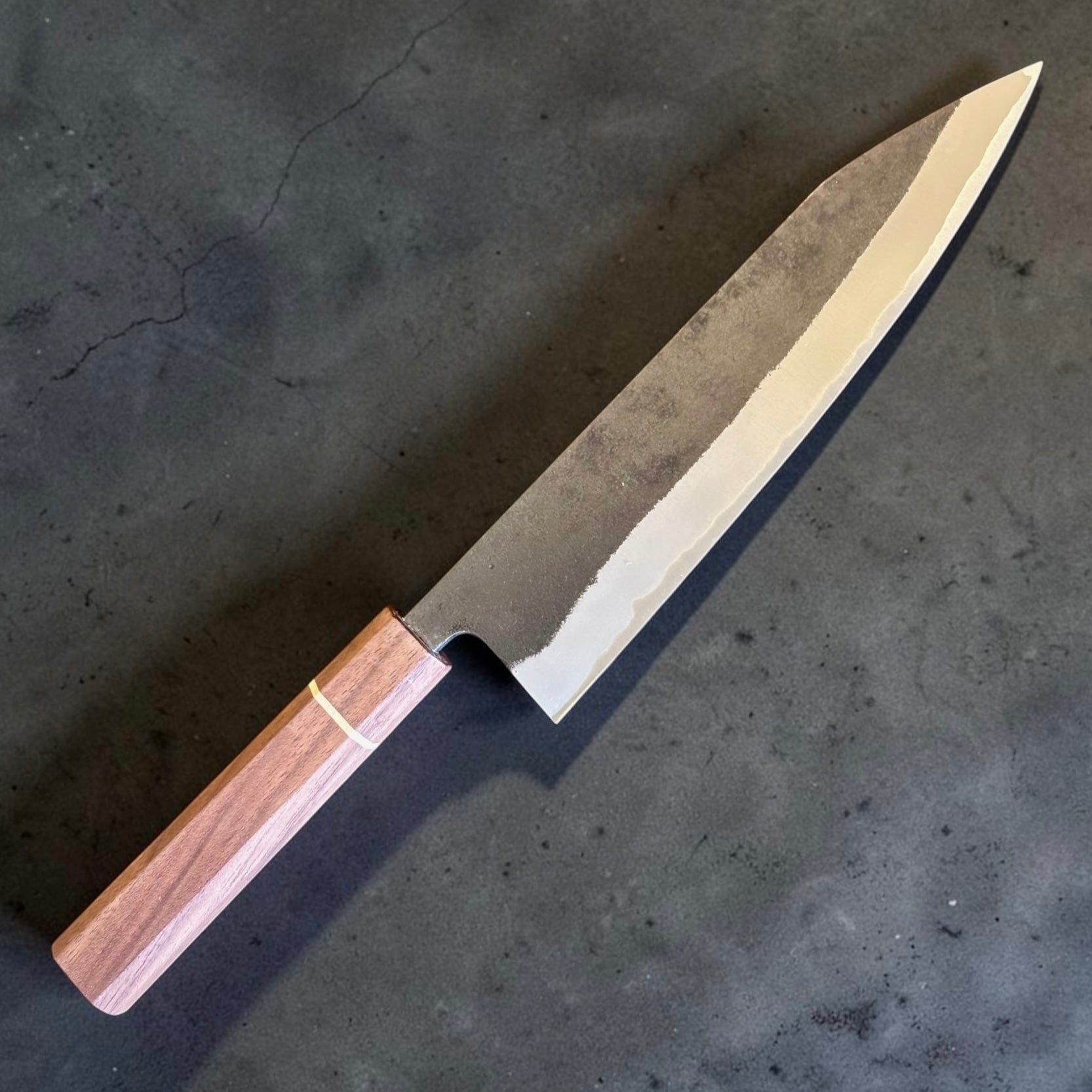 Imai Aogami Super Kurouchi Gyuto 210mm blade detail showing the stainless cladding line and polished cutting edge