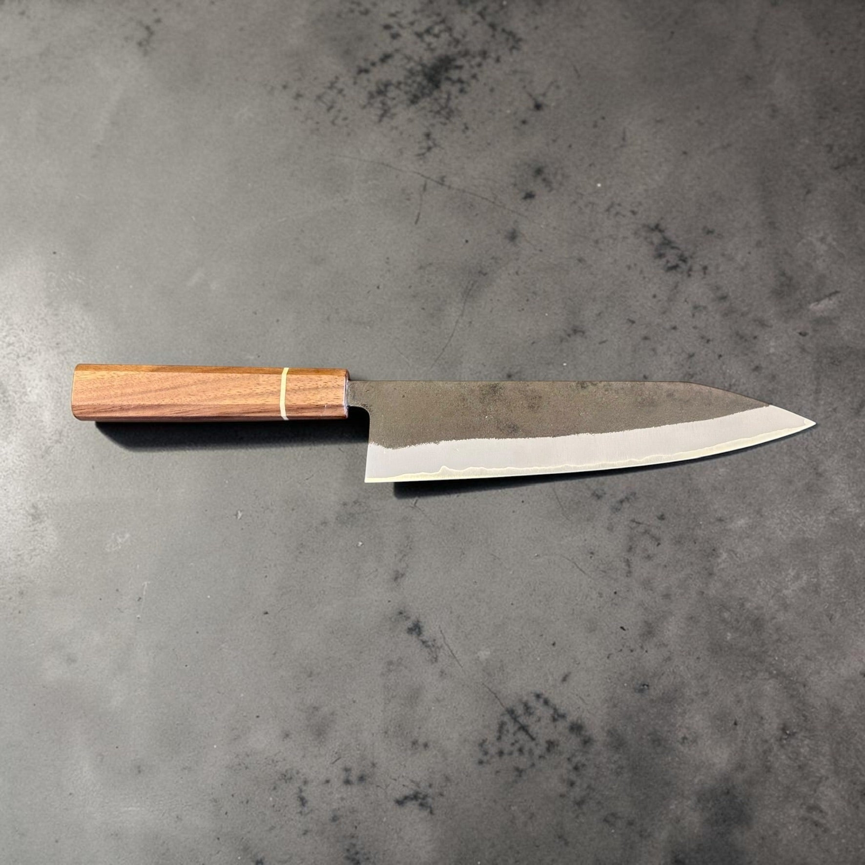 Left profile of the Imai Aogami Super Kurouchi Gyuto 210mm with Sanjo walnut handle