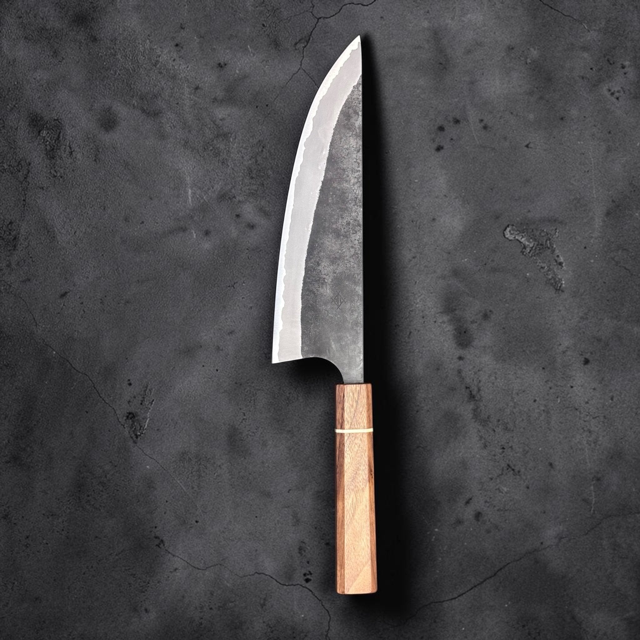 Imai AS Kurouchi USA Gyuto 220 mm with Sanjo walnut handle, vertical full knife view with dark textured background.