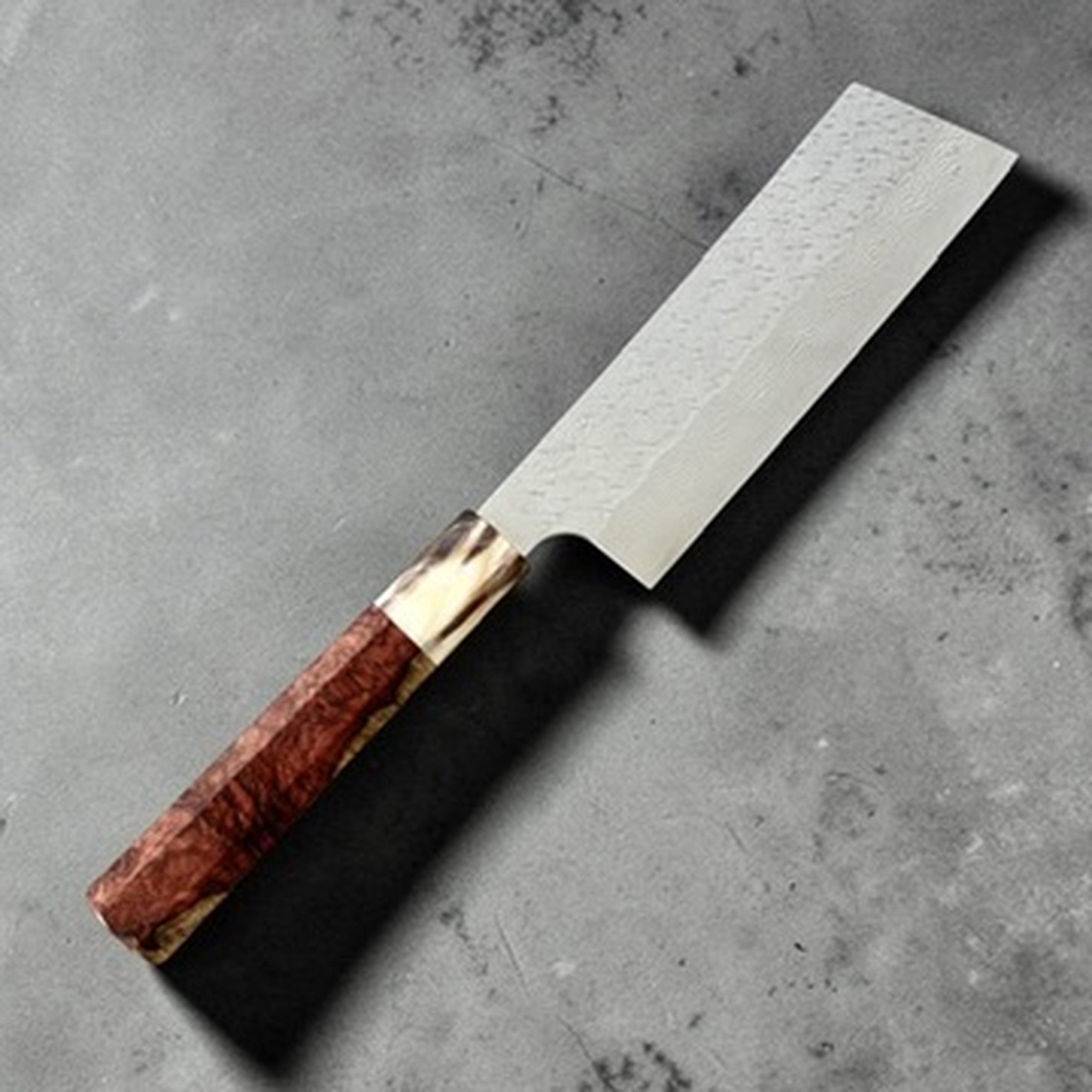 Nigara SG-STRIX Damascus Hakata Kiritsuke Nakiri with Amboyna Burl Handle, reverse angled view showing the hakata kiritsuke nakiri profile and custom amboyna burl handle.