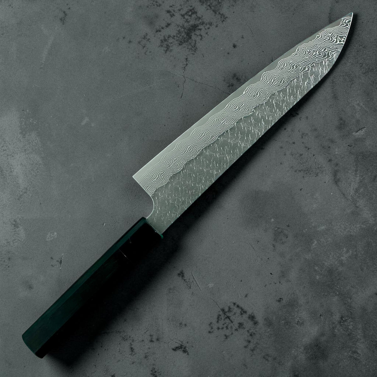 Nigara STRIX Tsuchime Damascus Gyuto 240mm met handvat van massief ebbenhout en hoorn, schuin achteraanzicht van het volledige mes