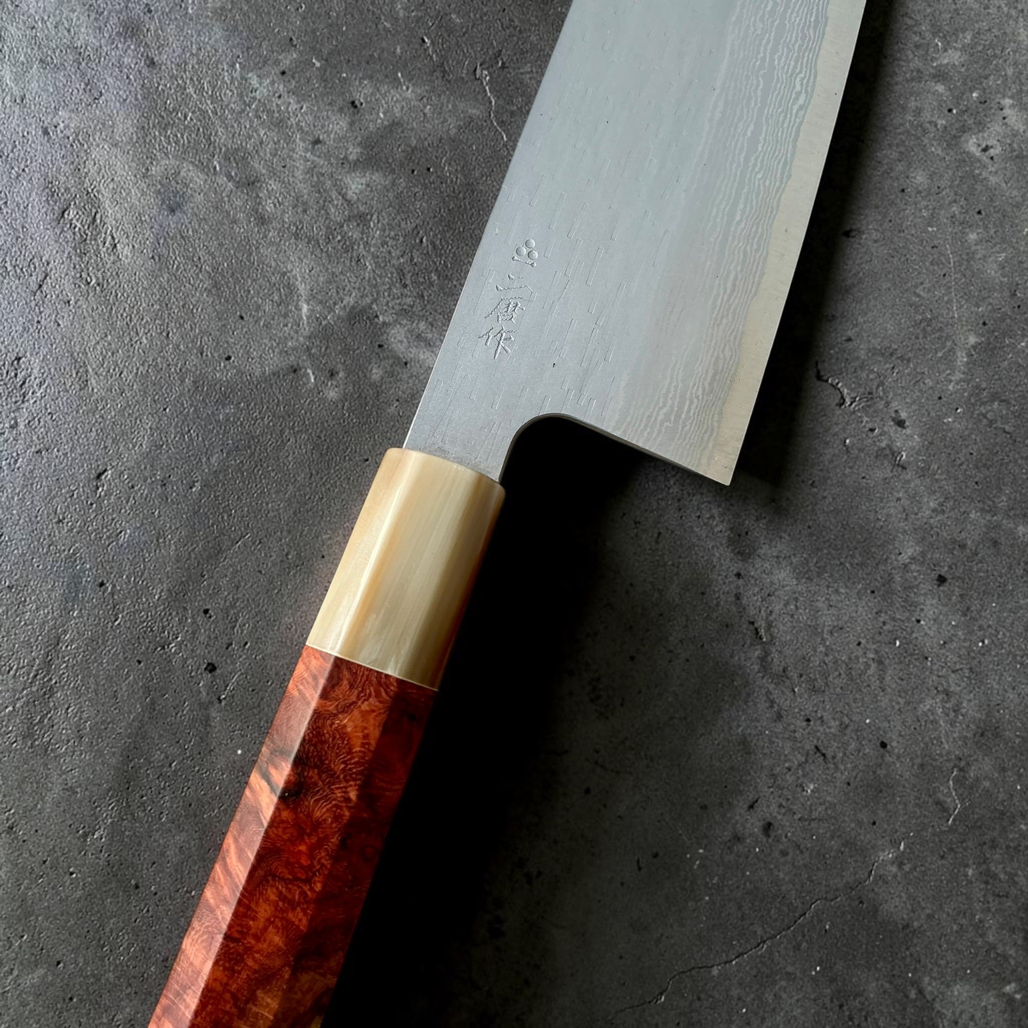 Nigara VG-XEOS nakiri close-up showing kanji, polished tsuchime finish and buffalo horn ferrule.