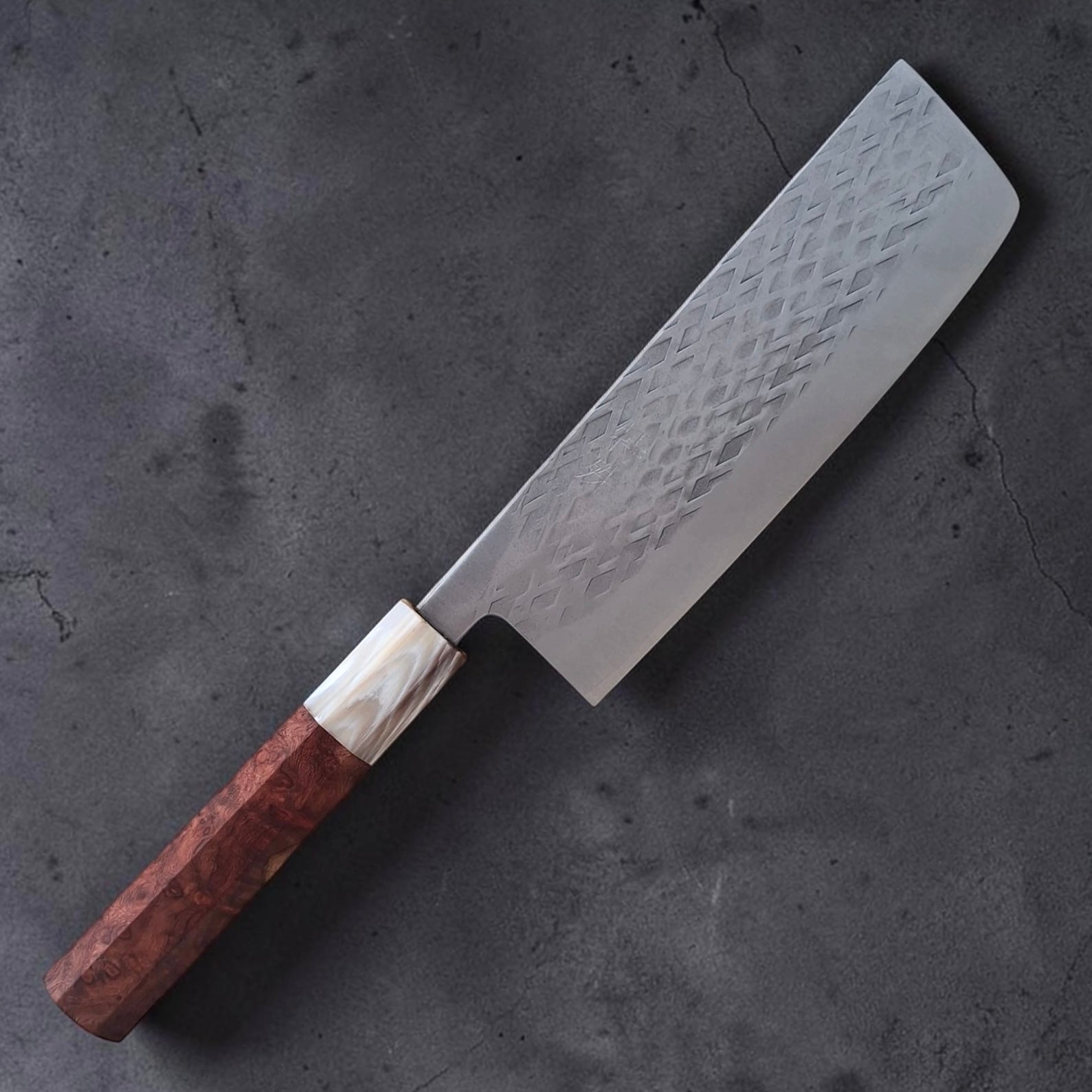 Overhead view of Tokushu Knife SLD Tsuchime Nakiri showing clean blade profile and tsuchime texture