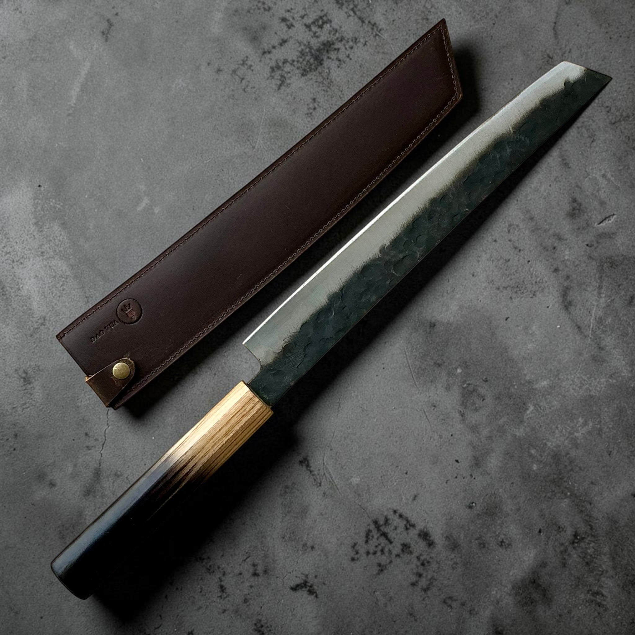Dao Vua V3 Sujihiki 270mm beside its leather sheath