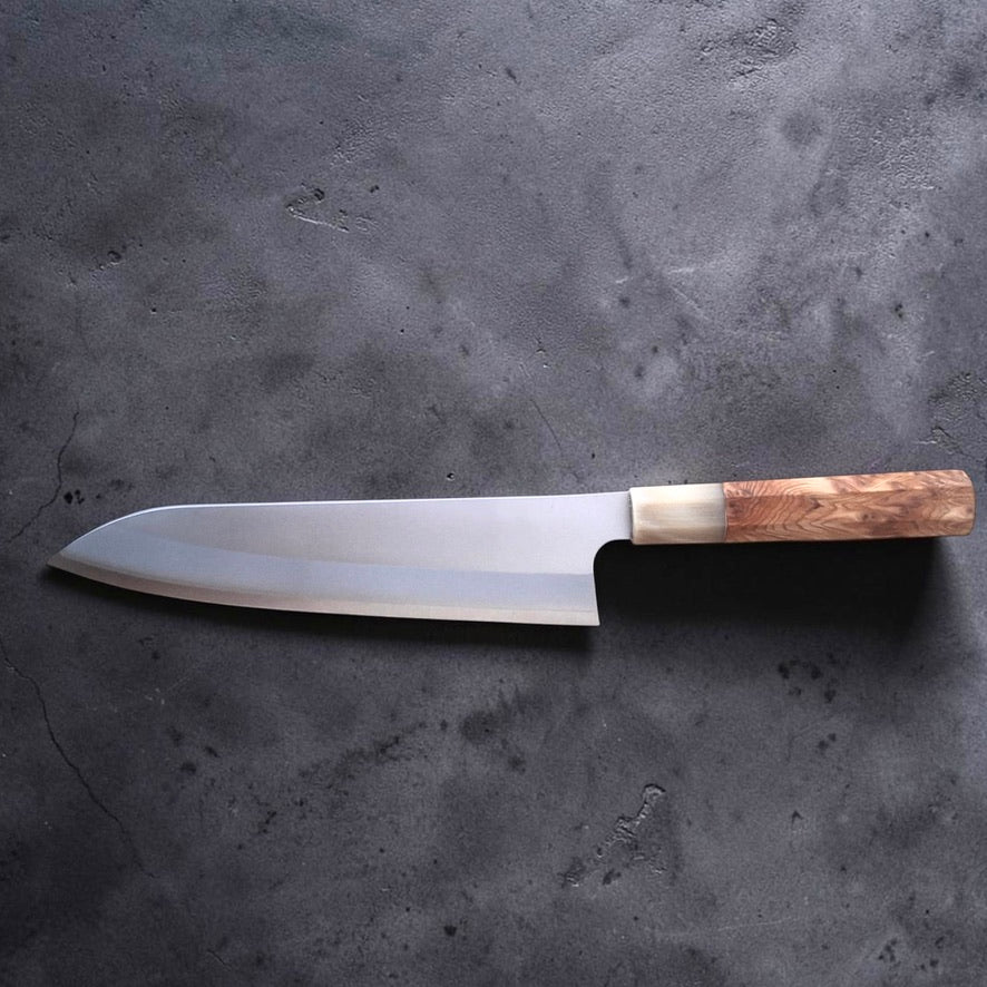 Daruma Hamono Ginsan #3 Migaki Gyuto 210 mm, reverse side profile with the blade facing left on a dark grey surface.