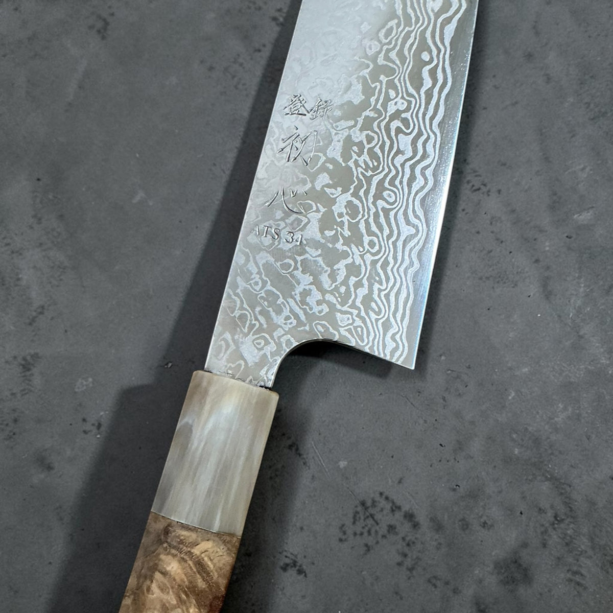 Hatsukokoro Ginga ATS-34 nickel Damascus santoku 180mm — Amboyna and buffalo horn handle, blade engraving and ferrule detail