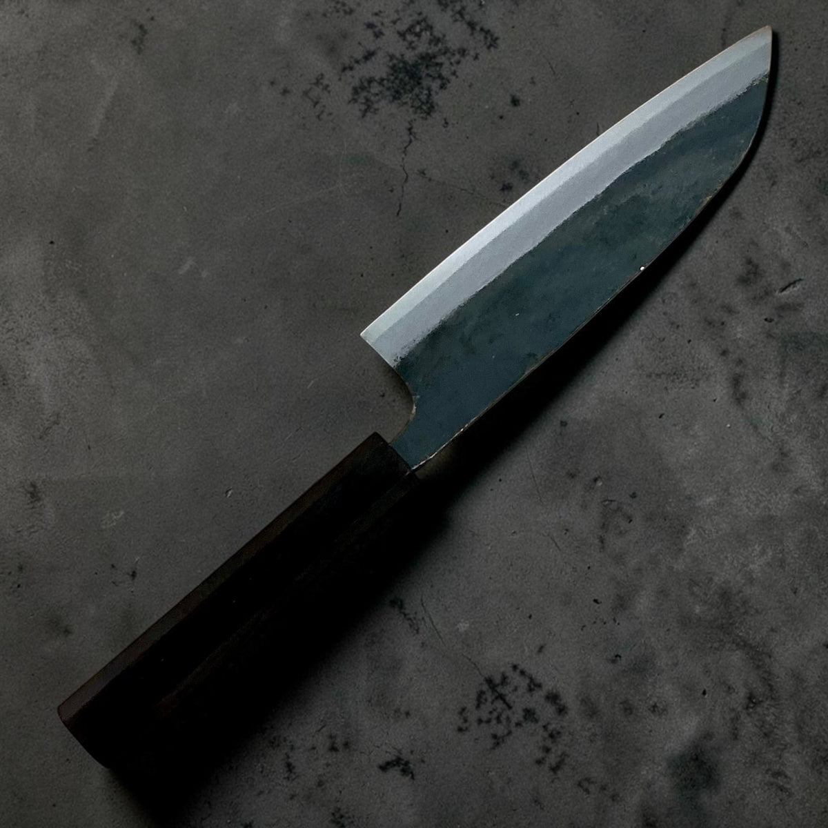 Reverse-side angled view of the Hatsukokoro Kokugei Blue #1 Kurouchi Santoku 165mm.