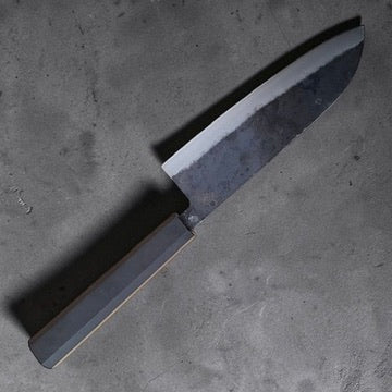 Angled view of the Hatsukokoro Kurogane Blue #2 santoku with ebony wa handle