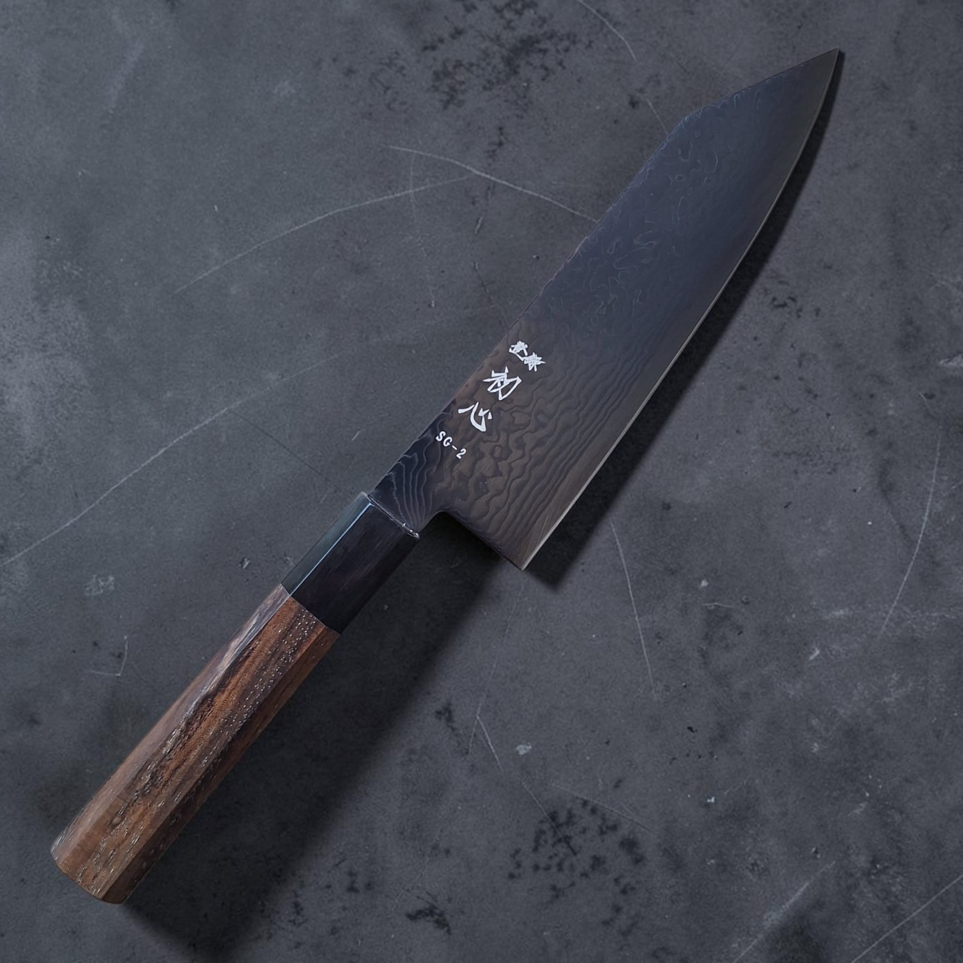 Hatsukokoro Ryuhyo black SG2 Damascus Bunka 180mm with walnut handle, angled reverse view
