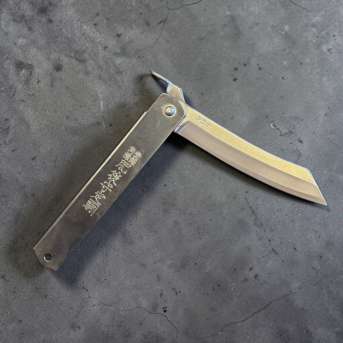 Higonokami Carbon Steel Japanese Friction Folder, three-quarter product view with blade partially open. #size_large - black