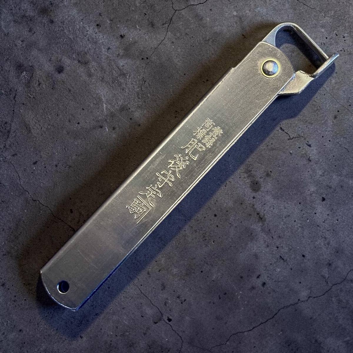 Higonokami Carbon Steel Japanese Friction Folder, closed handle detail showing engraved kanji. #size_large - black
