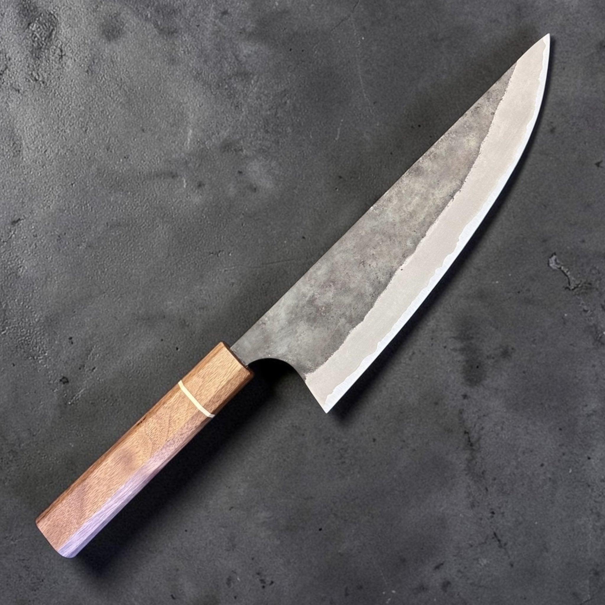 Imai AS Kurouchi USA Gyuto 220 mm with Sanjo walnut handle, angled full knife view showing kurouchi finish and polished edge.