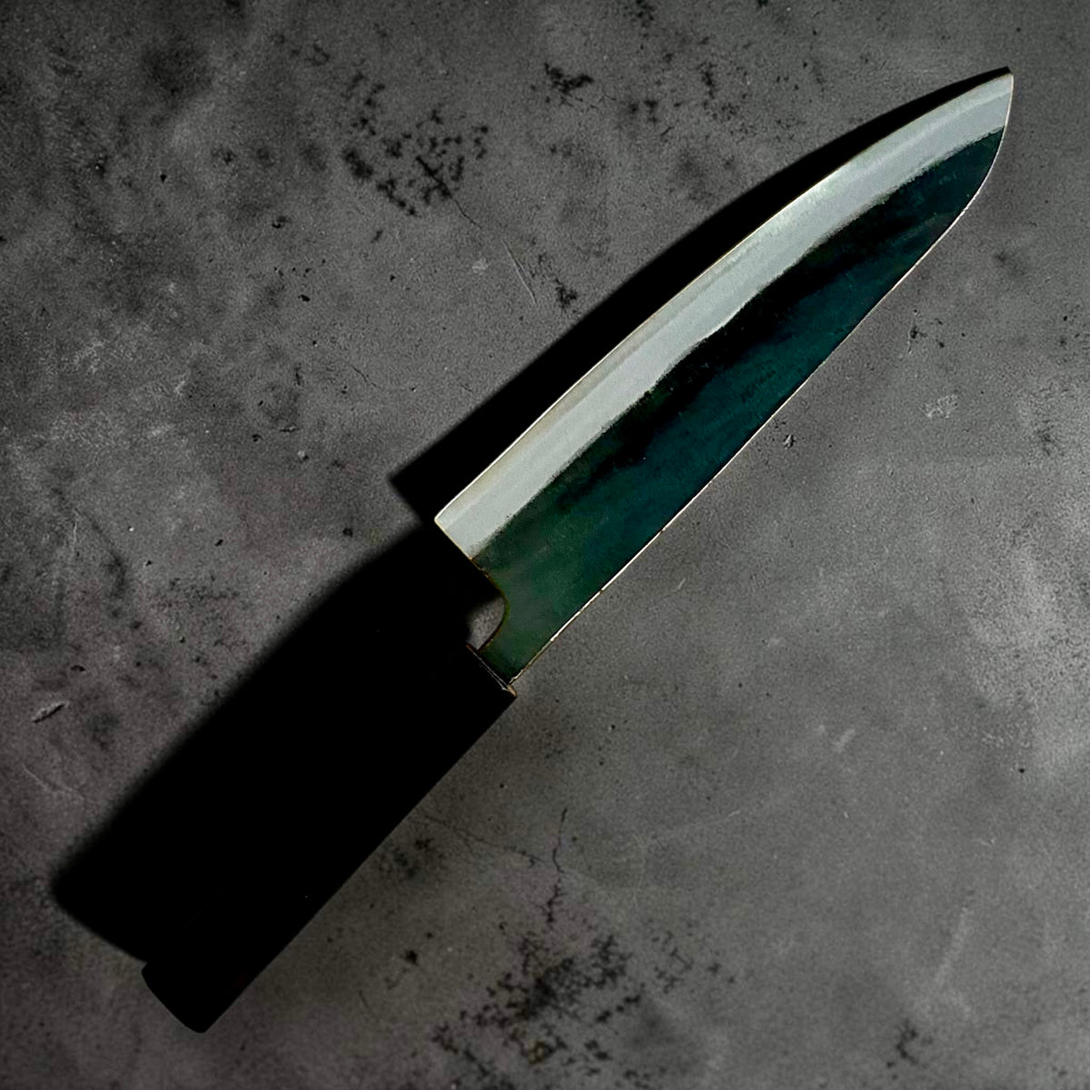Angled blade view of the Kokugei Blue #1 kurouchi gyuto 210mm