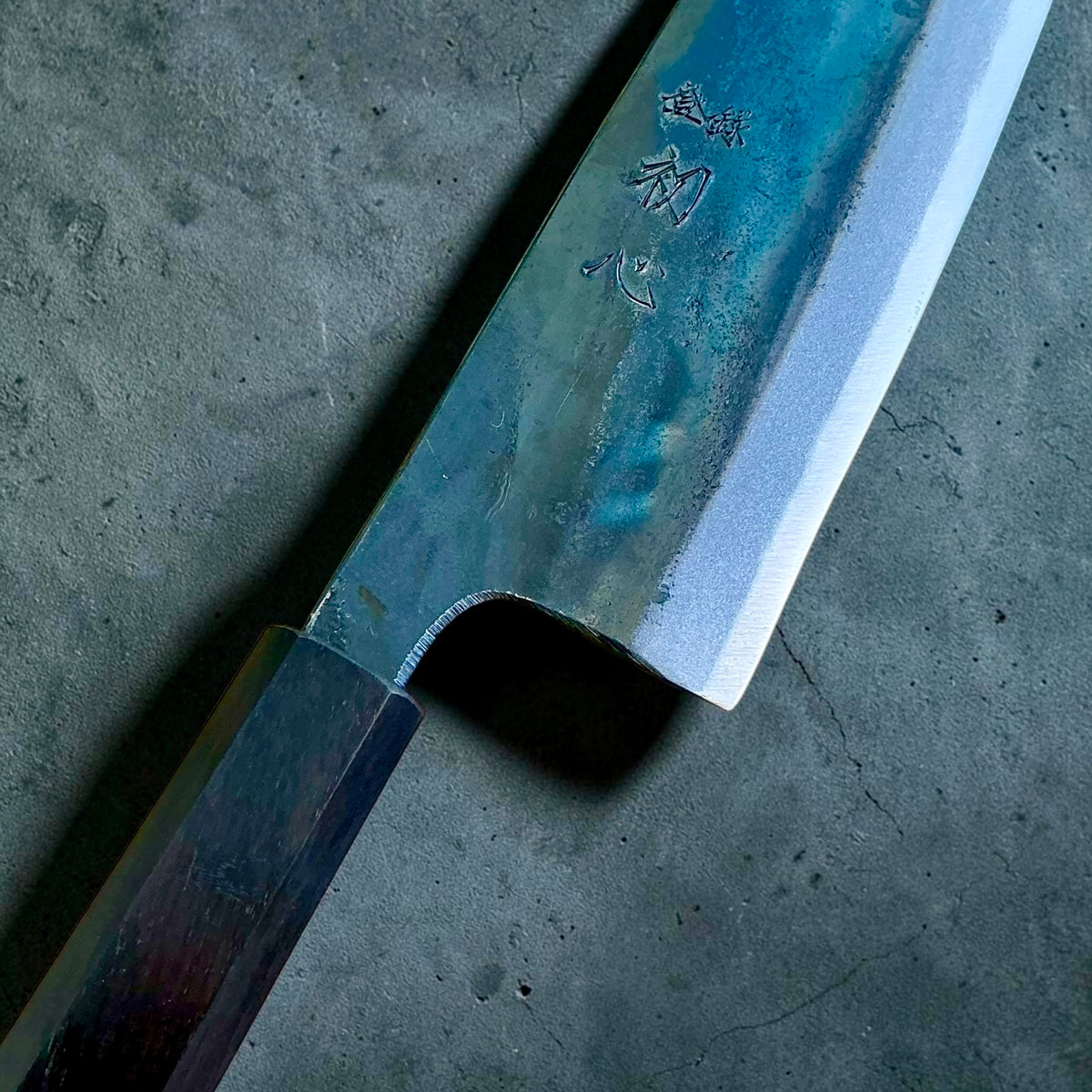 Close-up of the kurouchi finish and engraved kanji on the Kokugei Blue #1 gyuto