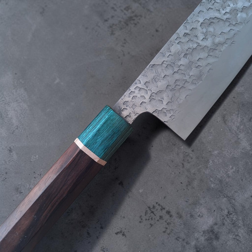Close-up of hammered blade and green ferrule on Makoto Kurosaki SG-STRIX gyuto