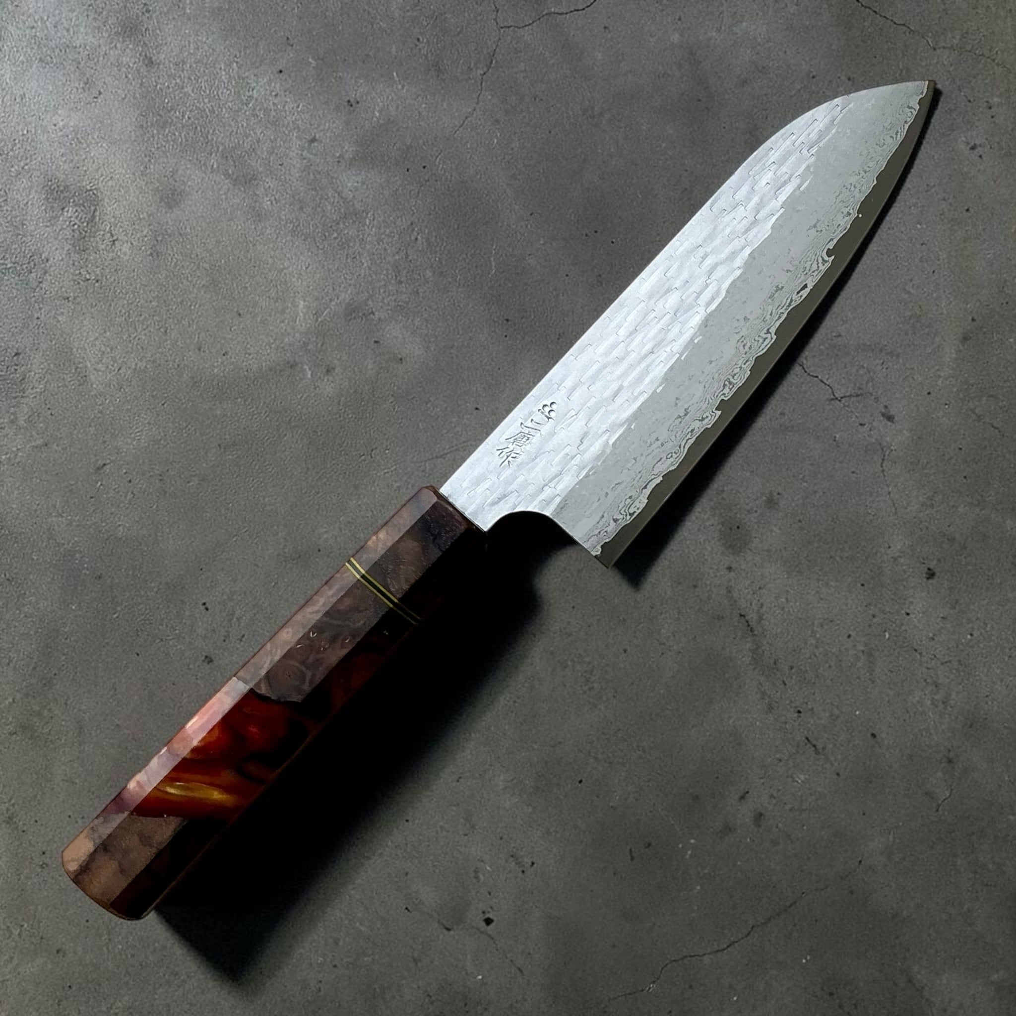 Nigara VG-XEOS polished tsuchime santoku 170mm with red-brown Prisma custom handle, kanji-side view.