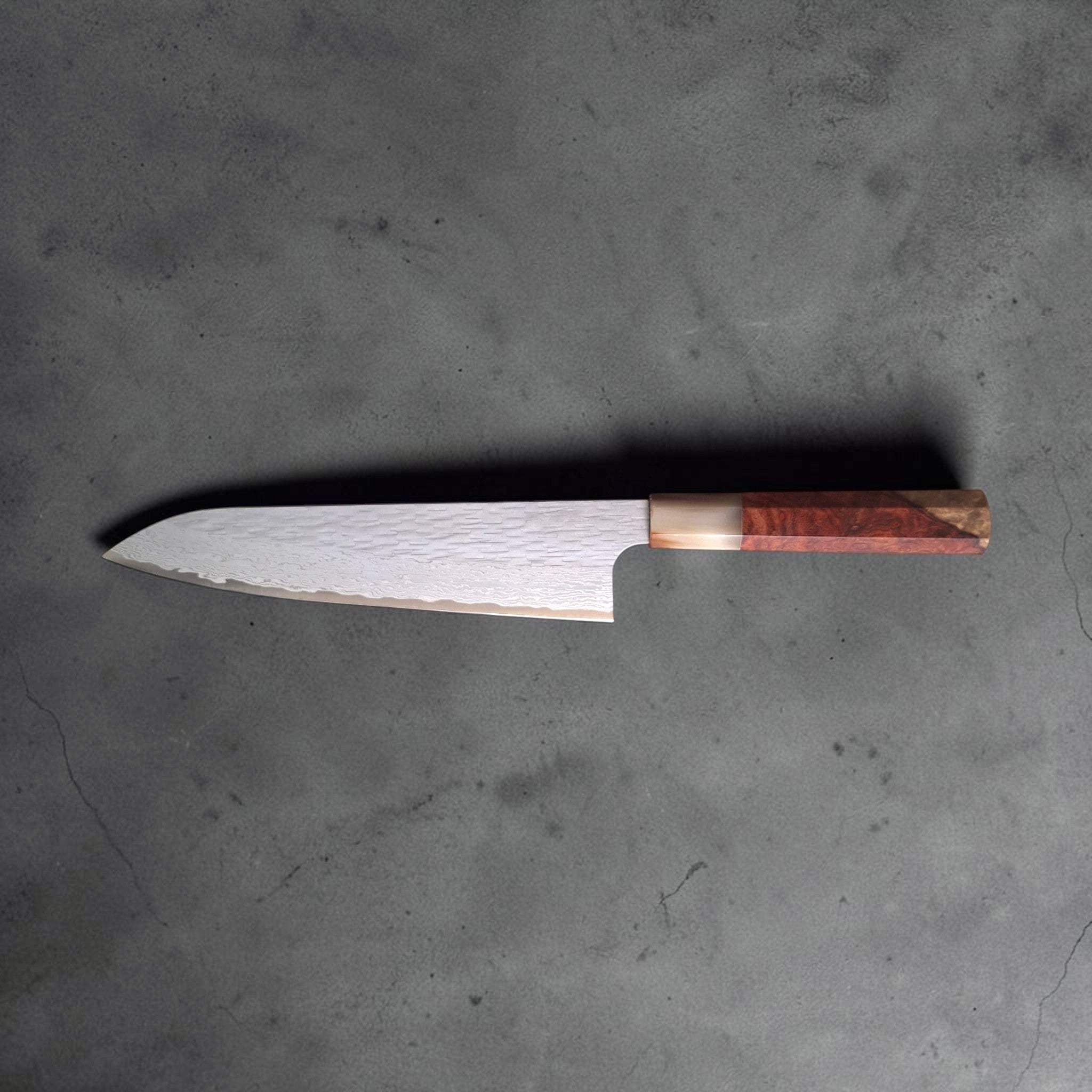 Nigara VG XEOS Tsuchime Gyuto 210 mm with amboyna burl and horn handle, horizontal profile view showing the slim gyuto blade.