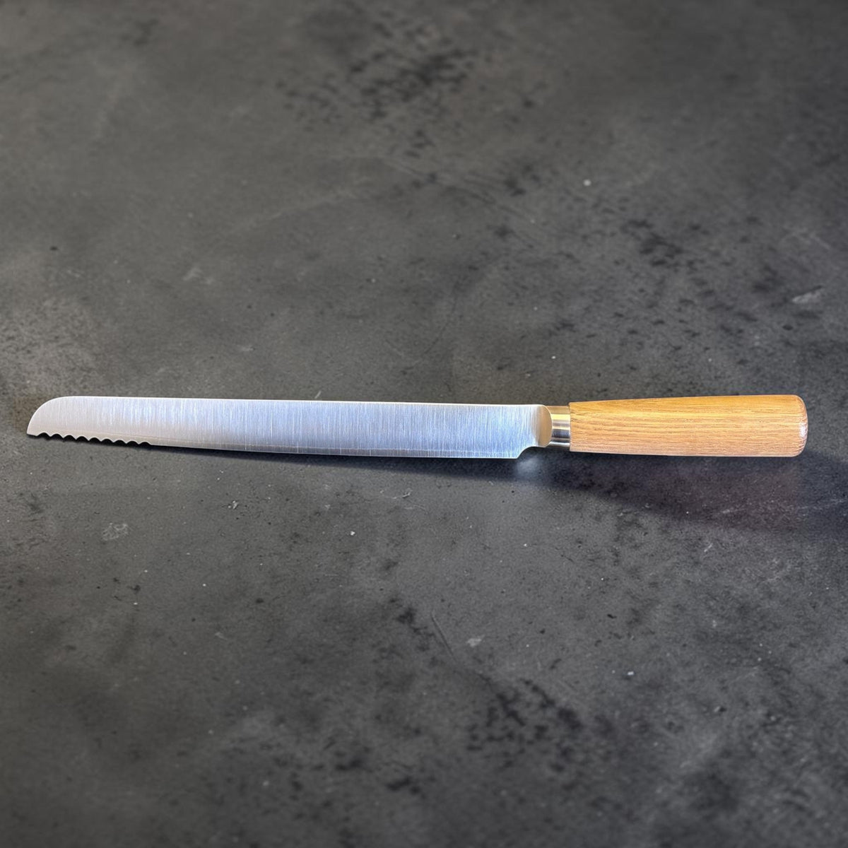 Tadafusa SLD Coltello da pane con manico in legno chiaro, profilo laterale del retro che mostra l’acciaio SLD satinato e l’innesto del manico.
