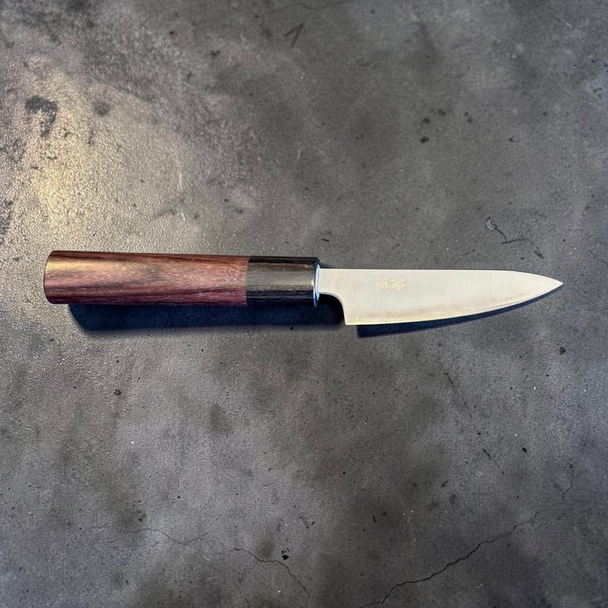 Tokushu Aogami Super Migaki Petty 80mm full profile on dark stone