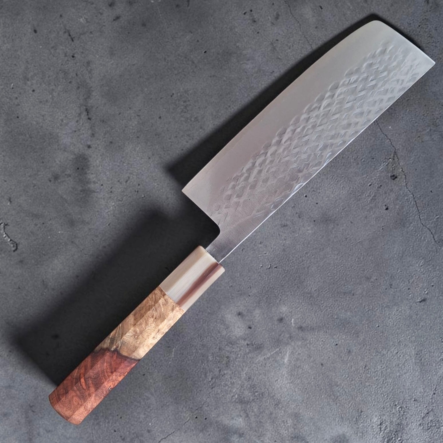     Tokushu Knife SLD Tsuchime Nakiri with custom reddish wood and light ferrule handle angled blade view