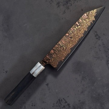 Angled full view of the Tu Nguyen 210mm rainbow Damascus kiritsuke gyuto